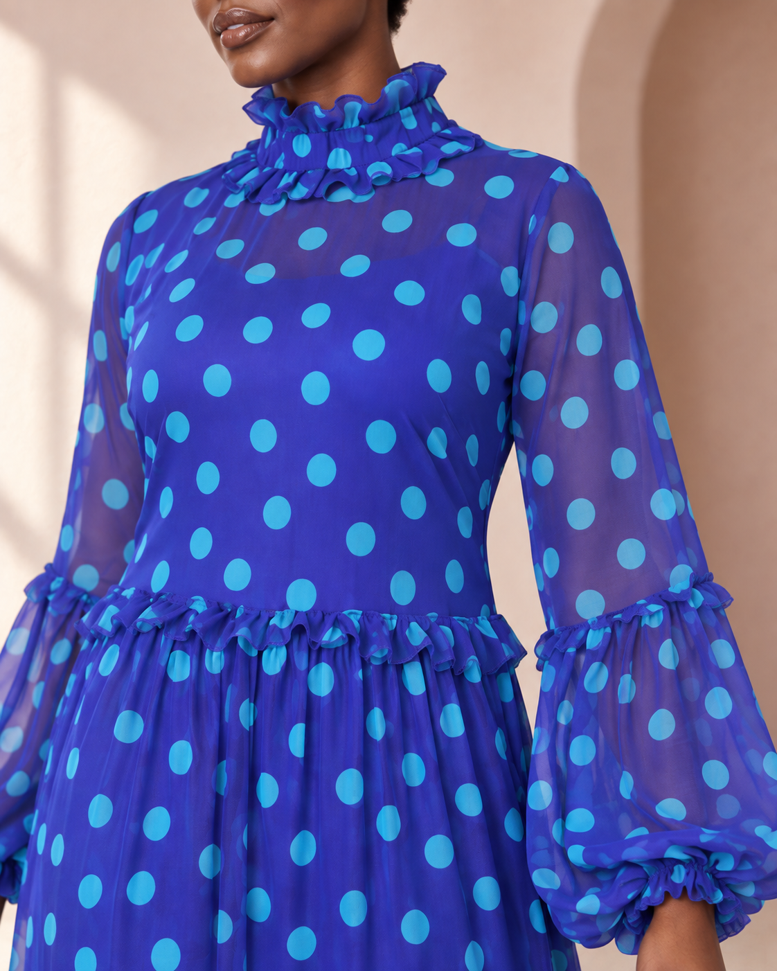 Close-up of the blue and turquoise polka-dot tiered maxi dress fabric and ruffles